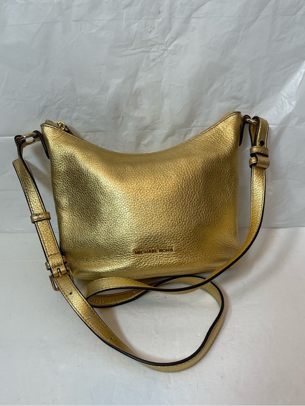 Michael Kors Gold leather hobo crossbody bag.